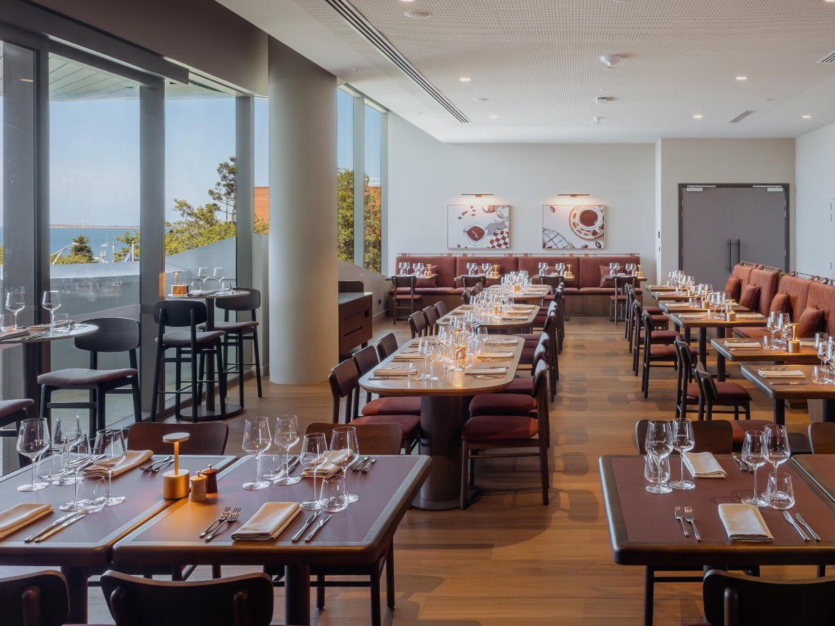 Elegant Italian-style restaurant dining room with waterfront views.